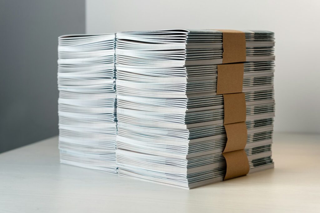 Bundles of newly printed catalogues in a stack